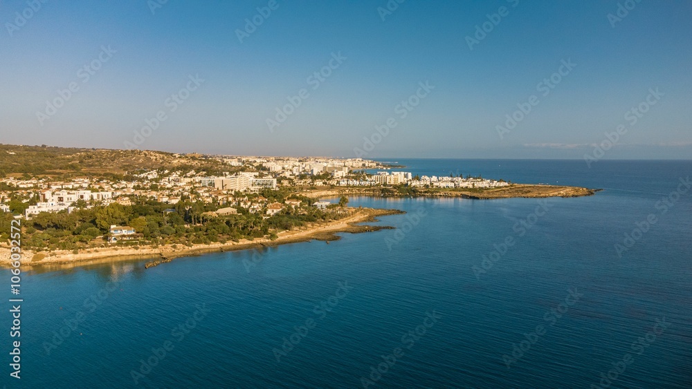 Aerial view of a coastal town with clear blue waters. Aerial view of a coastal town with clear blue waters.