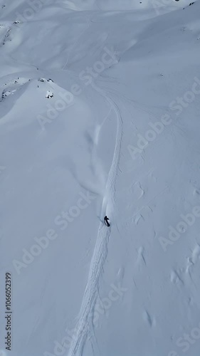Exploring untouched snowy mountains with skiers carving trails in the fresh powder
