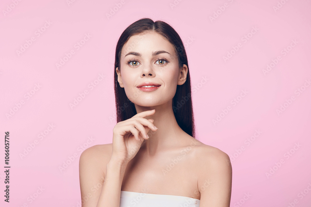 Beautiful young woman with her chin resting on her hand posing against a pink background Beautiful young woman with her chin resting on her hand posing against a pink background