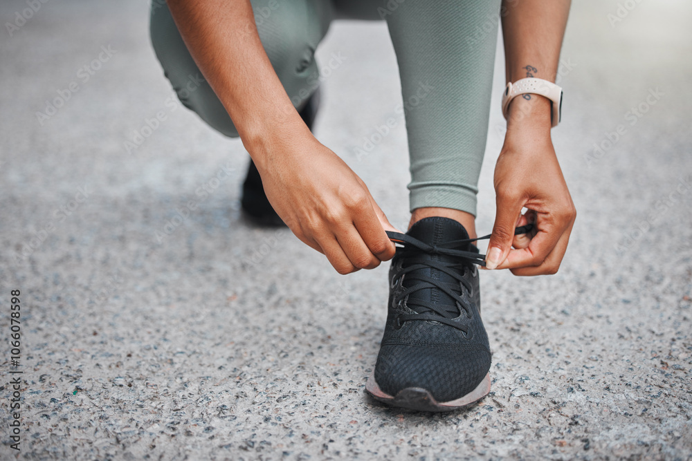 Obraz premium Fitness, woman and hands tying shoes outdoor to prepare for training, exercise and start workout for health on road. Sneakers, tie laces and runner ready for wellness, sports and closeup on street