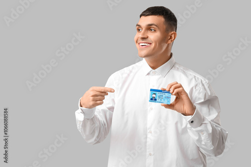Young happy man pointing at...
