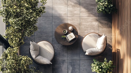 Top view of a modern balcony with two chairs, a coffee table, and potted plants.