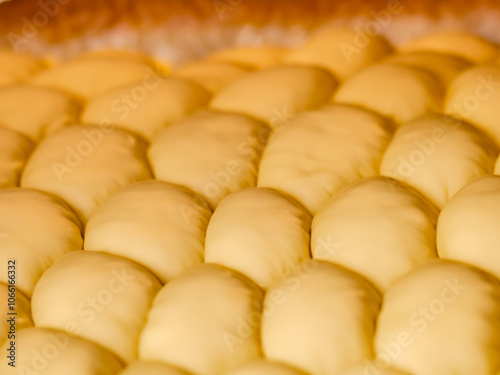 Abstract dough texture close up. Homemade bread honeycomb shape. Bread on baking pan hot out of the oven. photo