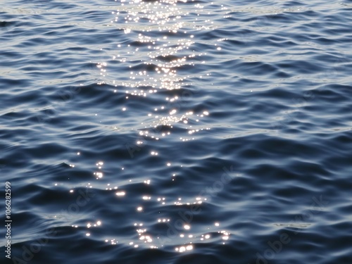 Shimmering water ripples on a still lake surface, clear water, mirror-like