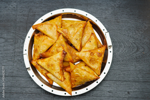 Samosa samoosa on white wooden background, Spicy Indian Snack, Kerala Traditional snack, top view, kerala snack samoosa, Triange shaped crispy snack named as samosa samoosa, top view white background. photo