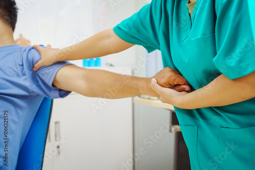 A female doctor performs physical therapy on a male patient in the hospital, using techniques like pulling, massaging, and compressing to rehabilitate injuries, relieve pain,restore daily functional