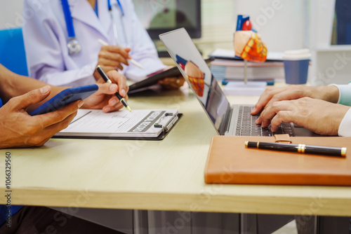 Doctors meet at a hospital desk to discuss a patient’s heart health, including conditions like coronary artery disease, arrhythmia,cardiac muscle disease,congenital issues, infectious heart diseases