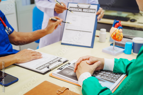 Doctors meet at a hospital desk to discuss a patient’s heart health, including conditions like coronary artery disease, arrhythmia,cardiac muscle disease,congenital issues, infectious heart diseases photo