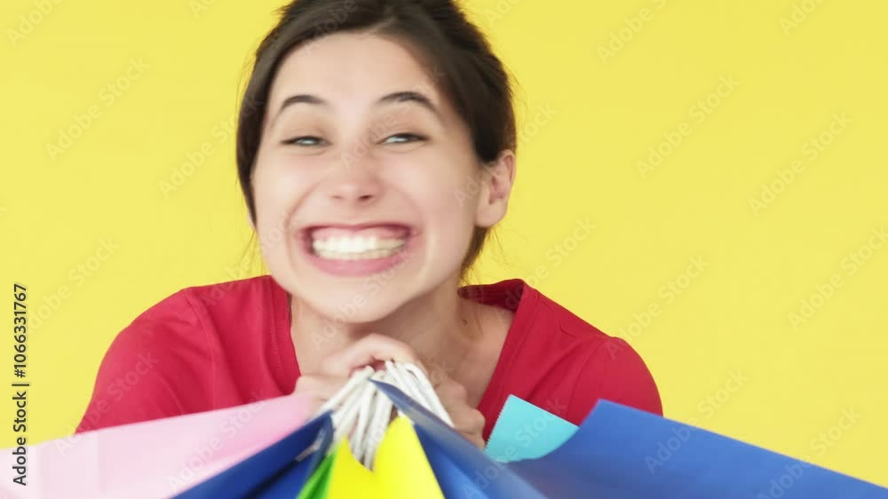 Satisfying shopping. Gift therapy. Excited happy woman receiving many paper bags joyful delighted client isolated on yellow free space background.