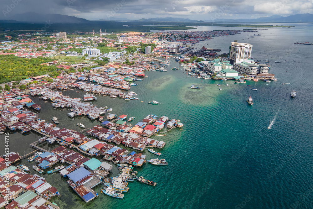 Obraz premium Aerial drone view of commercial pier and fisherman village at Semporna, a city on east coast of Sabah in Malaysia, Tawau District, Borneo island