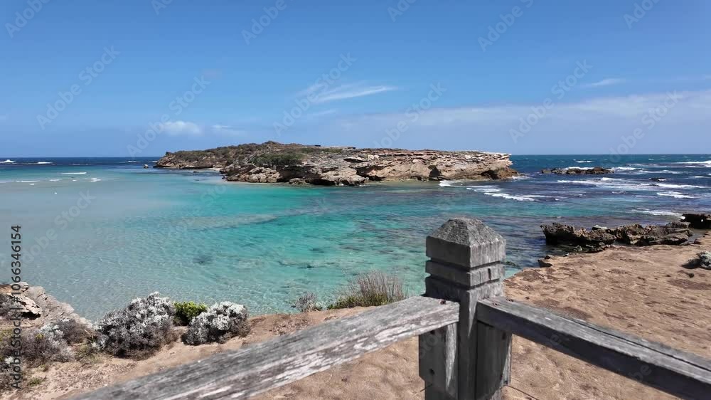 Scenic view of Merri Marine Sanctuary from a viewing platform with a lookout railing in Warrnambool, Australia, featuring a clear turquoise-blue coastline with waves and rocky outcrops. Scenic view of Merri Marine Sanctuary from a viewing platform with a lookout railing in Warrnambool, Australia, featuring a clear turquoise-blue coastline with waves and rocky outcrops.