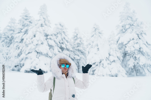 Woman tourist sightseeing Snow monster in Winter day at Mount Zao, Yamagata prefecture, Japan. Happy Traveler walking on powder snow covered in frosty weather. Travel, Adventure and Vacation photo