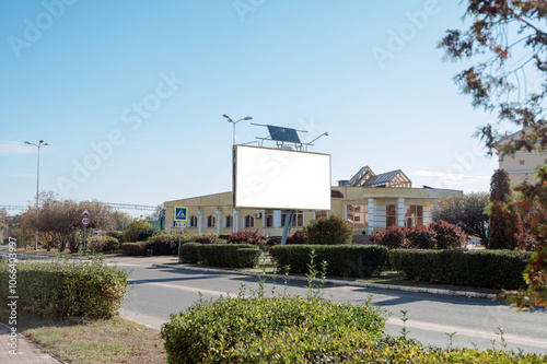 Large blank advertising poster, billboard banner mockup in front of building in city photo