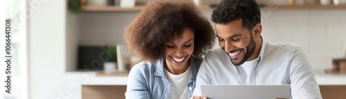 Couple smiling while reading through favorable mortgage terms, celebrating savings, warm ambiance photo