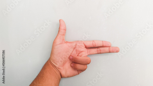 a person's hand on a gray background