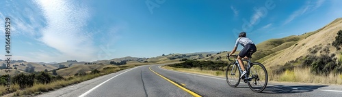 Glossy Cyclist Scenic Road Image with Clear Sky Space for Text | Perfect for Cycling Gear Ads, Fitness Programs, Outdoor Activities Promotion | Stock Photo Concept for Active Lifestyle