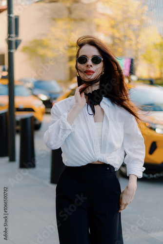 Stylish woman by yellow taxi in city, exuding elegance and sophistication