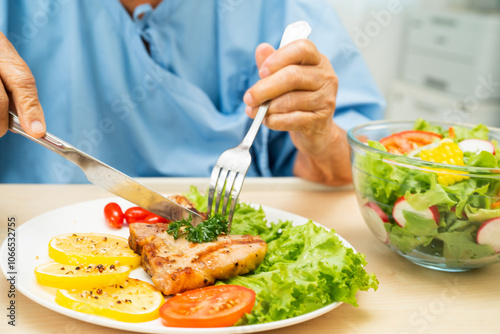 Wallpaper Mural Asian senior woman patient eating pork chop stake and vegetable salad for healthy food in hospital. Torontodigital.ca