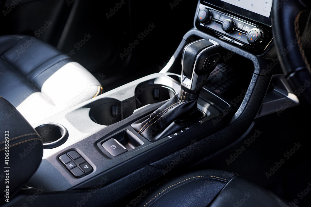 Fototapeta premium automatic transmission shift selector in the car interior. Closeup a manual shift of modern car gear shifter. 4x4 gear shift