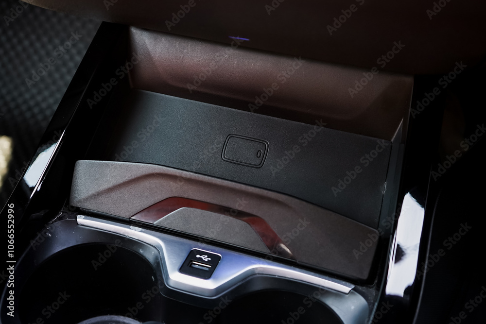 Obraz premium Wireless mobile charger in the modern car. Portable wireless car charger for smartphone.