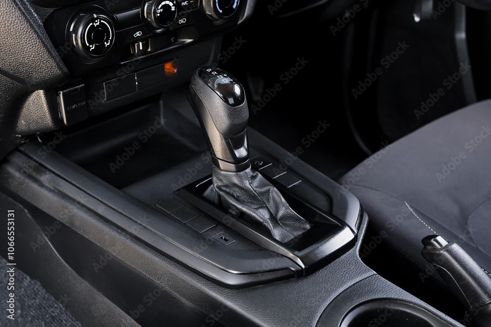 automatic transmission shift selector in the car interior. Closeup a manual shift of modern car gear shifter. 4x4 gear shift automatic transmission shift selector in the car interior. Closeup a manual shift of modern car gear shifter. 4x4 gear shift