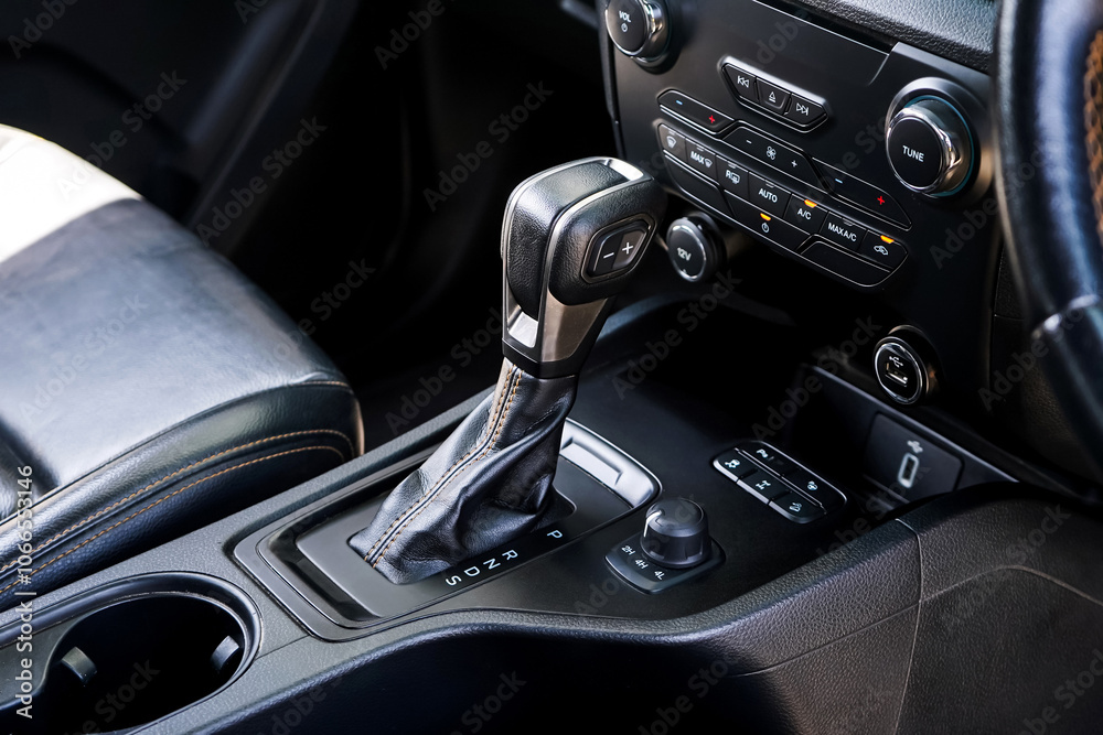 automatic transmission shift selector in the car interior. Closeup a manual shift of modern car gear shifter. 4x4 gear shift automatic transmission shift selector in the car interior. Closeup a manual shift of modern car gear shifter. 4x4 gear shift