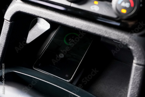 Wireless mobile charger in the modern car. Portable wireless car charger for smartphone.