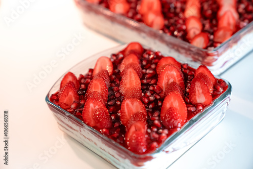 Tasty cake with fresh strawberries and mint isolated on white Red velvet cake with fresh strawberries. Festive layered cake from red sponge cakes and cream cheese frosting.