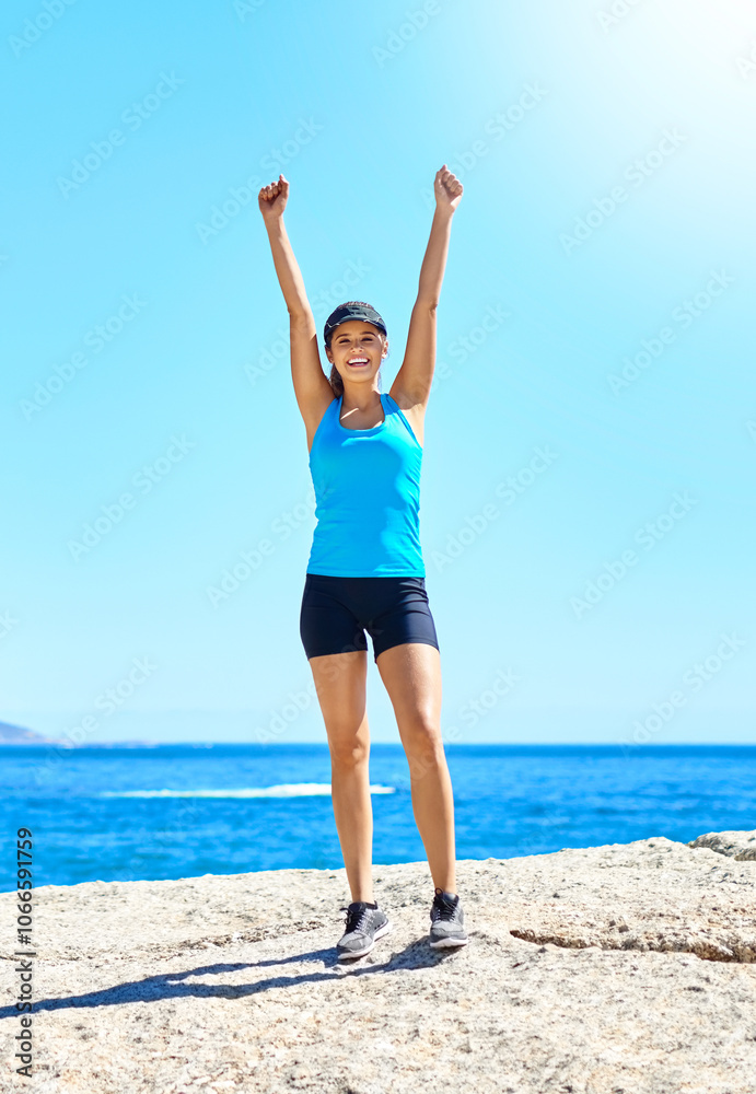Fitness, success and woman on beach with achievement, smile and outdoor training exercise. Ocean, celebration and girl runner with arms up, blue sky and morning workout goals in nature for body care Fitness, success and woman on beach with achievement, smile and outdoor training exercise. Ocean, celebration and girl runner with arms up, blue sky and morning workout goals in nature for body care