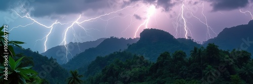 Lightning strikes over a lush jungle and mountain range photo