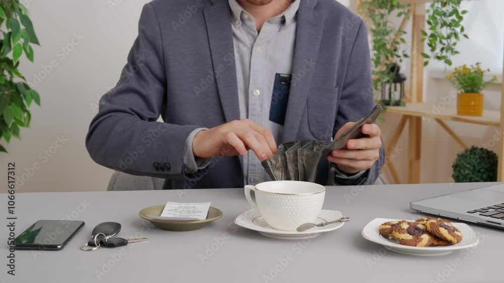 Man sitting at table at cafe restaurant opens wallet and paying bill with cash coins. Commercial business payments. Man sitting at table at cafe restaurant opens wallet and paying bill with cash coins. Commercial business payments.