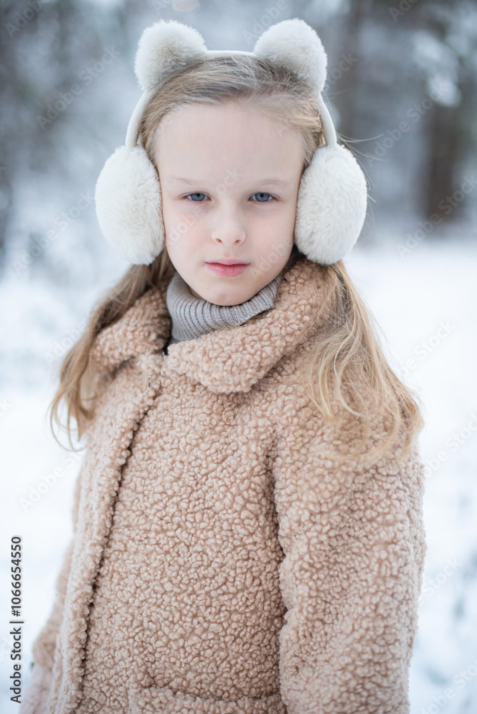Little girl in winter clothes walks in the snowy forest Little girl in winter clothes walks in the snowy forest