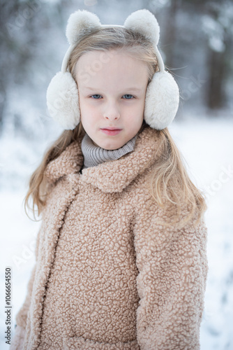 Принти на полотні Little girl in winter clothes walks in the snowy forest