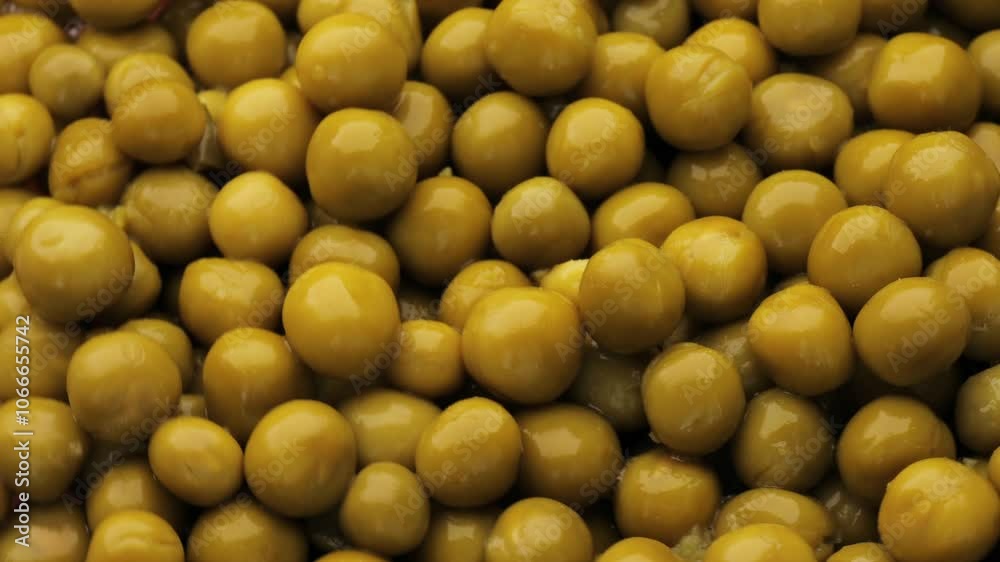 Marinated pickled sweet green peas rotating in a circle. Fresh canned green pea kernels turning, showcasing vibrant texture and color Marinated pickled sweet green peas rotating in a circle. Fresh canned green pea kernels turning, showcasing vibrant texture and color