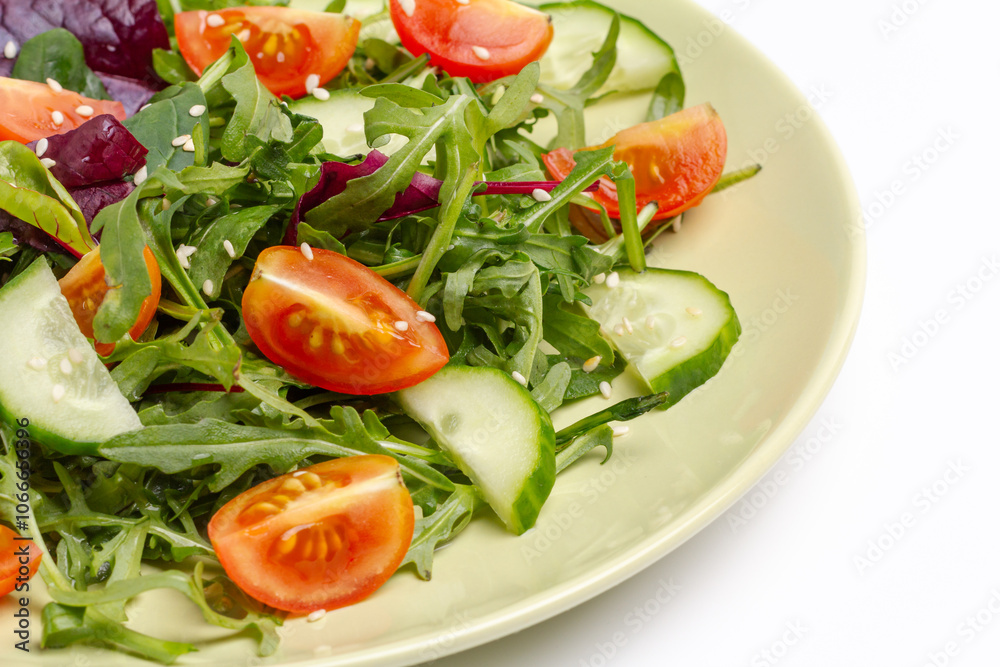 Vegetable salad of tomato, cucumber, greens with sesame on the plate. Vegetable salad of tomato, cucumber, greens with sesame on the plate.