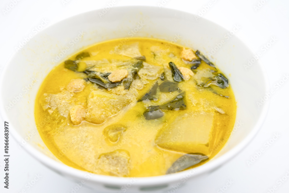 A vibrant bowl of green soup with leafy greens and chunks of meat, showcasing a hearty and comforting dish. A vibrant bowl of green soup with leafy greens and chunks of meat, showcasing a hearty and comforting dish.