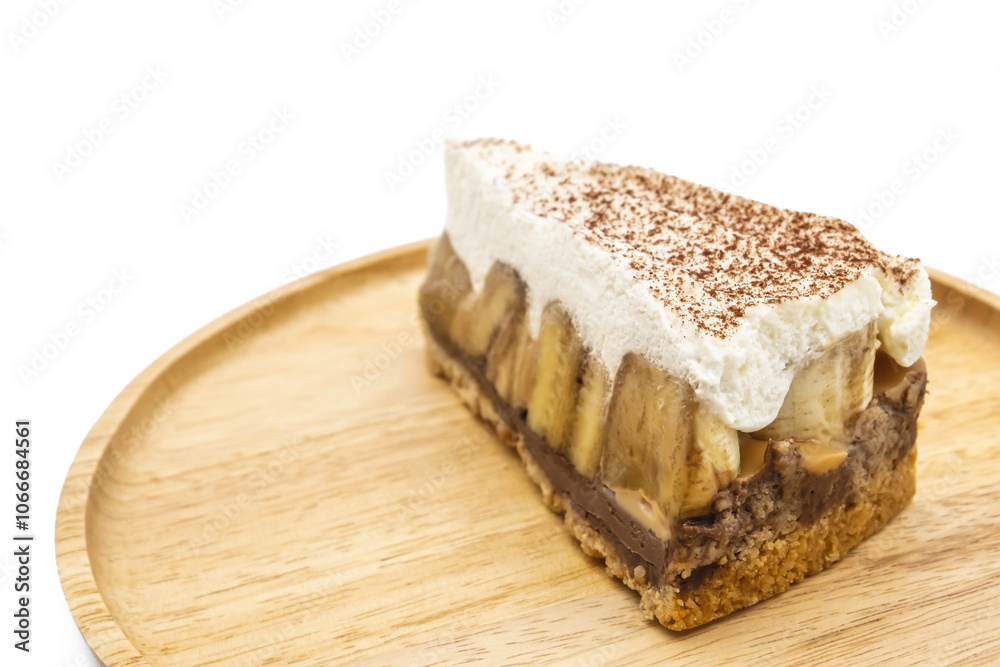 Banoffee Pie, whipped cream and banana on the wooden plate isolate white background Banoffee Pie, whipped cream and banana on the wooden plate isolate white background