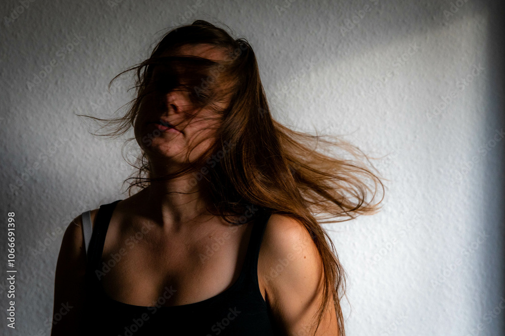 Female Caucasian shaking her long brown hair and head Female Caucasian shaking her long brown hair and head
