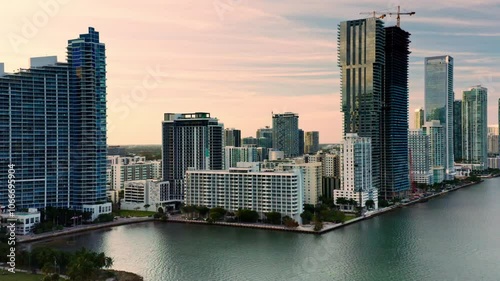 A truly breathtaking view of Miamis stunning skyline along the shimmering water, showcasing impressive modern architecture contrasted beautifully against a vibrant and colorful sunset. Florida. USA