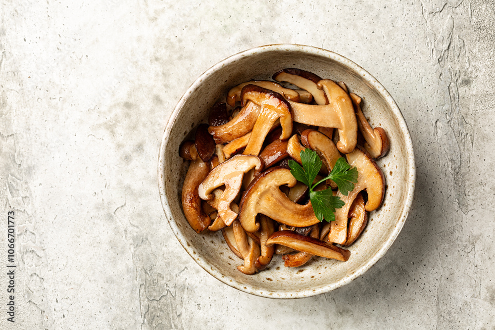 Top view of Fried with garlic oak mushroom. The shiitake or black forest mushrooms is an edible mushroom native to East Asia. Top view of Fried with garlic oak mushroom. The shiitake or black forest mushrooms is an edible mushroom native to East Asia.