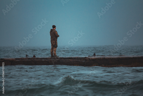 Tableau sur toile Soldier on Pier in Stormy, Foggy Weather