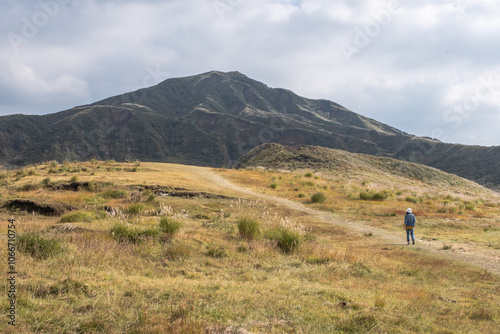 Woman standing in the green lanscape with mountain Aso background, Kusasenri, Aso, Kumamoto, Kyushu, Japan photo