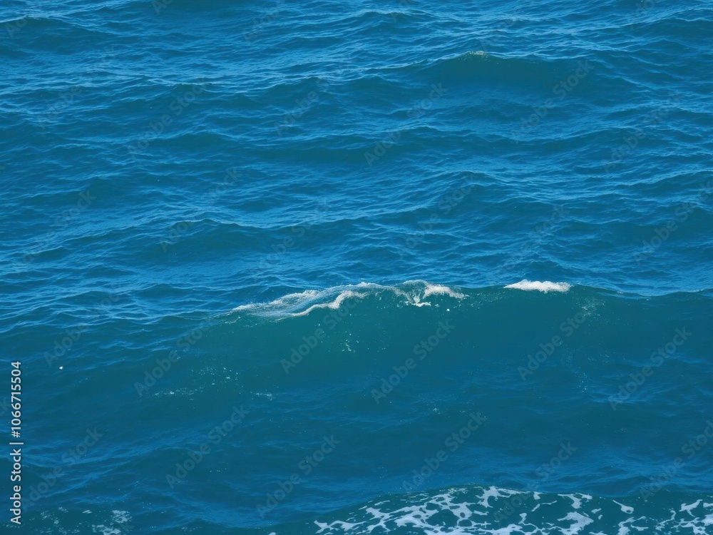 Blue sea with gentle waves and foamy white caps in a peaceful, serene texture, water, blue Blue sea with gentle waves and foamy white caps in a peaceful, serene texture, water, blue