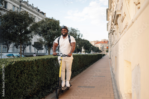 Smiling delivery man riding electric scooter in city center