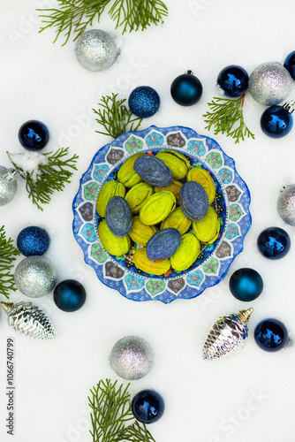 Christmas or New Year green and blue homemade cookies called Nuts stuffed with condensed milk and walnuts surrounded with Christmas balls 