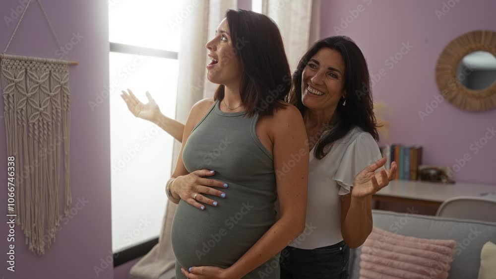Pregnant woman enjoying a loving surprise from her mother in a cozy living room, with a bookshelf and macramé wall hanging in the background.