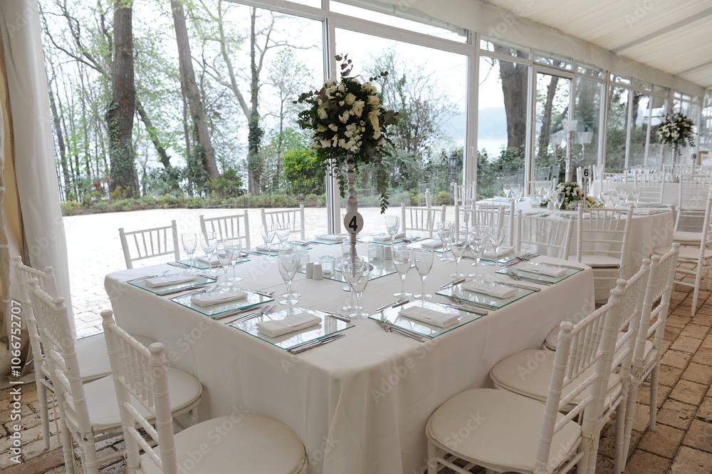 Beautiful Wedding Decor: Round Tables with Purple Details and White Floral Arrangements