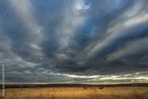 A cloudy sky with a few clouds in the distance