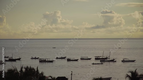 Boats on the Indian Ocean off Zanzibar, as clouds pass by above 