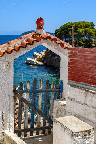 Through the gate, sea view looking down on the beach at Plakes. Part of the Sporades islands, Greece. Holiday and vacation picture. photo